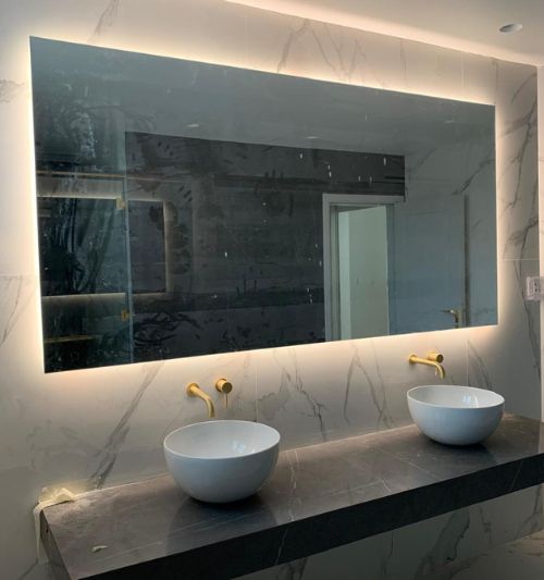 Custom wall mirror installation in Dubai apartment bathroom